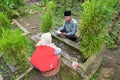 A mother and father and one son are reading the holy Koran to pray for someone who has died