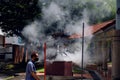 Singapore Aug2021 Heavy smoke from concrete burner as residents burn joss paper money as offerings to the dead during 7th month Royalty Free Stock Photo