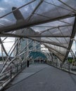 People walking at the Helix Bridge with Marina Bay Sands in background