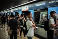 Singapore:August 22, 2023-The crowded passengers waiting for entering the train at the platform of the station Royalty Free Stock Photo