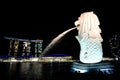 Singapore:August 20, 2023- Side view of Merlion spraying the water with cityscape at night and lake in background Royalty Free Stock Photo