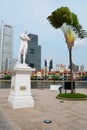 Sir Thomas Stamford Bingley Raffles statue with modern buildings at the background in Singapore, Singapore. Royalty Free Stock Photo