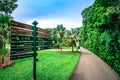 Path way with directional sign post at Singapore Botanic Gardens. Royalty Free Stock Photo