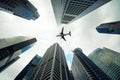 Singapore city buildings and a plane flying overhead in morning Royalty Free Stock Photo
