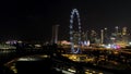 Singapore - 25 September 2018: Singapore city skyline at night with the river, purple lighted Ferris wheel and famous