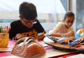 Singapore-09 DEC 2017:India children drawing traditional mask in workshop Royalty Free Stock Photo