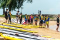 Singapore East Coast Beach. Team bonding. Group of Asian water sports men and women windsurfers on beach having discussion