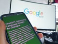 Singapore - Feb 2023: A mobile phone showing ChatGPT and off focus computer screen showing Google Bard in focus