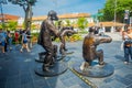SINGAPORE, SINGAPORE - FEBRUARY 01, 2018: Bronze sculpture named Paparazzi Dog by Gillie and Marc Schattner, outdoor
