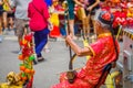 SINGAPORE, SINGAPORE - FEBRUARY 01, 2018: Elder street musician busking along a busy street during Chinese New Year in