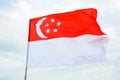 The Singapore flag with red white horizontal bands crescent moon and five stars flying