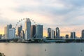 Singapore Flyer Cityscape On Marina Bay And Sunset In Twilight Time . Taken Photo From Marina Barrage