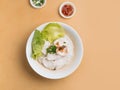 singapore food Sliced Fish Bee Hoon in bowl with soup, chili sauce and spring onion top view on wooden table Royalty Free Stock Photo