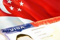 Singapore immigration document close up. Passport visa on Singapore flag. Singapore visitor visa in passport,3D rendering. Royalty Free Stock Photo