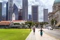 Tourists go to the city cricket club and the old clock tower against the backdrop of modern Downtown Royalty Free Stock Photo