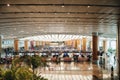 Singapore - June 2019 - Tourists and travellers wait in line to check in at Changi International Airport check in counters