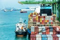 Large container ship with cargo in the containers berthed under gantry cranes at the container terminal