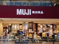 Frontage of an almost empty MUJI store in Jewel Mall, Changi Airport, Singapore. An Asian lady wearing a mask stands at the