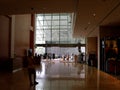 A woman waits and other people enter the reception hall of tower 3 of the Marina Bay Sands hotel.