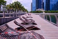 Empty deserted marina bay waterfront promenade; covid-19 coronavirus outbreak no people. Public deck chairs taped over; safe
