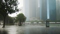 Singapore, 26 May 2018. Heavy rain in the center of Singapore. People with an umbrella are walking in the rain.