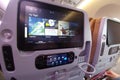 Singapore - May 06, 2019: Modern multimedia system of the aircraft located in the passenger seats. Large monitor in the back of