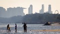 Leisure image of people enjoysthe beach with Singapore central district buildings