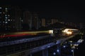 Singapore MRT track and station at night with light trail from train lights. Royalty Free Stock Photo