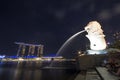 Merlion statue fountain in Merlion Park and Singapore city skyline at night Royalty Free Stock Photo