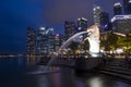 Merlion statue fountain in Merlion Park and Singapore city skyline at night Royalty Free Stock Photo