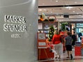 SINGAPORE - 17 NOV 2019 - White Caucasian shoppers enter a Marks & Spencer store