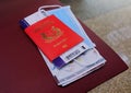 Singapore passport, face mask, boarding pass, map on chair. Airport environment Royalty Free Stock Photo