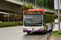 Singapore SBS public bus on road approaches bus stop