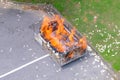 Singapore Sep2021 Large metal container of burning joss paper offerings by residents during Hungry Ghost Festival. Litter of paper