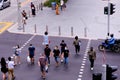 Singapore Sep2020 Top angle of people wearing face masks crossing a road selective focus. Crowd picks up in Orchard Road during