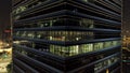 Singapore - 25 September 2018: Close up for exterior of modern office building corner with lighted windows and people