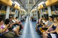 Singapore, Singapore - August 19, 2015 : Indoor view of people in a rail commuters ride a crowded Mass Rapid Transit MRT train