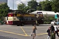 Bio Bus with tourists onboard in downtown Singapore with some pedestrians crossing the