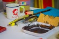 SINGAPORE, SINGAPORE - JANUARY 30, 2018: Close up of assorted tools with a brown painting inside of a plastic tray
