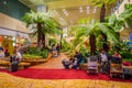 SINGAPORE, SINGAPORE - JANUARY 30, 2018: Indoor view of unidentified people sitting in a chairs in a small garden with