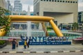 SINGAPORE, SINGAPORE - JANUARY 30. 2018: Unidentified people close to a fountain wealth with a public residential