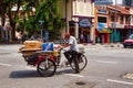 Senior citizen with hand cart on street