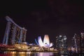 Singapore skyline with the ArtScience Museum and Marina Bay Sands Hotel with night lights reflected in the water of the bay