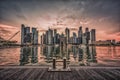 Singapore Skyline and view of business district downtown with wooden walkway on Marina Bay at sunset. Vintage tone Royalty Free Stock Photo