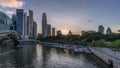 Singapore skyscrapers skyline with white Anderson Bridge near esplanade park day to night timelapse.