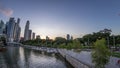 Singapore skyscrapers skyline with white Anderson Bridge near esplanade park day to night timelapse.