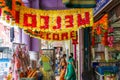 Singapore street with shops and flower garland with women in sari walking