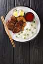 Singapore Teochew Braised Duck Lor Ark served with rice, eggs and tofu close-up in a plate. Vertical top view Royalty Free Stock Photo
