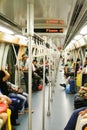 SINGAPORE - MARCH 24. 2008: View inside wagon of sky train with passengers Royalty Free Stock Photo