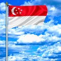 Singapore waving flag against blue sky